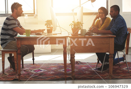Coworking, web designer and team in office with work and lens flare of small business. Startup, teamwork and staff in a workplace with communication of tech group with website design for project Coworking, web designer and team in office with work and lens flare of small business. Startup, teamwork and staff in a workplace with communication of tech group with website design for project 106947329