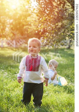 Toddler boy in Ukrainian vyshyvanka in summer. . 106947402