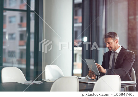 Tablet, typing and business man planning in office, conference room or glass reflection, data analysis and software. Professional person or corporate office CEO search analytics on digital technology Tablet, typing and business man planning in office, conference room or glass reflection, data analysis and software. Professional person or corporate office CEO search analytics on digital technology 106947403