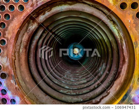 Central firing chamber of a plate and tube boiler that is open for maintenance and repair.  106947431