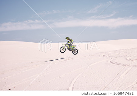 Bike, mockup and balance with a man in the desert riding a vehicle for adventure or adrenaline. Motorcycle, space and training on sand with an athlete outdoor in nature for freedom or active power 106947481