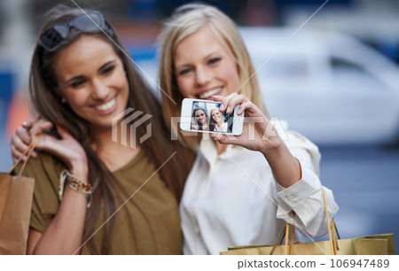 Shopping hug, selfie and happy customer, friends or women with memory picture of Black Friday spree, sales or product purchase. Social media, city fashion or stylish female people smile for shop deal 106947489