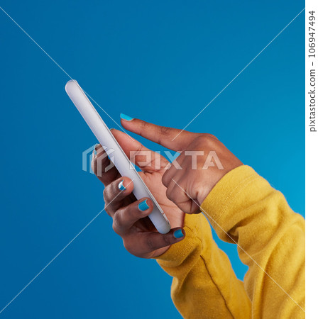 Phone, typing and hands of woman point to screen in studio for social media, text message and website. Communication, technology and girl on internet, networking and chat online on blue background 106947494