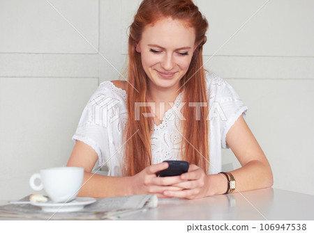 Coffee shop, phone and happy woman texting, relax and smile for chat app on wall background. Cafe, social media and female customer reading post, news or update while enjoying day off and tea break Coffee shop, phone and happy woman texting, relax and smile for chat app on wall background. Cafe, social media and female customer reading post, news or update while enjoying day off and tea break 106947538
