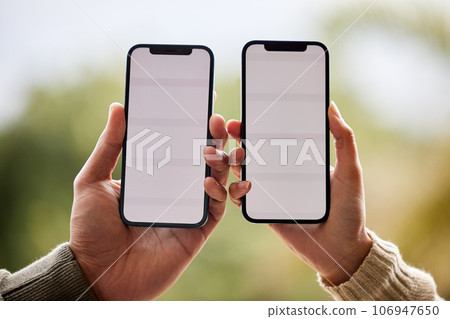 Its a match made in heaven. an unrecognisable couple holding their cellphones next to each other. 106947650