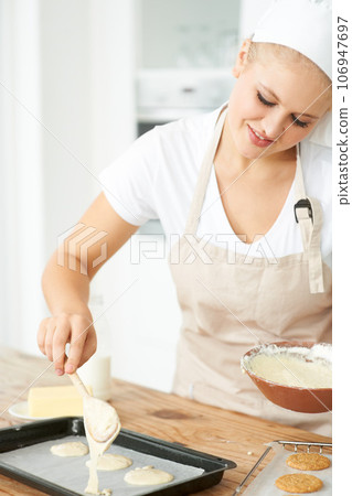 Happy woman, tray or chef baking cookies with dough or pastry in a bakery kitchen with recipe. Food business, dessert or girl baker smiling or working in preparation of a sweet meal, cake or biscuit Happy woman, tray or chef baking cookies with dough or pastry in a bakery kitchen with recipe. Food business, dessert or girl baker smiling or working in preparation of a sweet meal, cake or biscuit 106947697