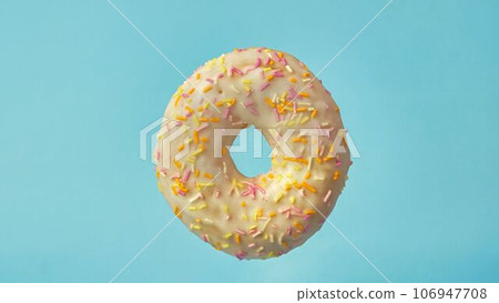 donut on a blue background close-up donut on a blue background close-up 106947708
