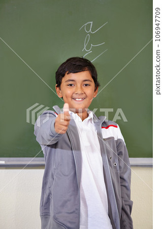 Portrait, child and thumbs up of student on chalkboard in classroom, elementary school and mockup. Blackboard, education and kid with hand gesture for like emoji, agreement and learning with a smile. Portrait, child and thumbs up of student on chalkboard in classroom, elementary school and mockup. Blackboard, education and kid with hand gesture for like emoji, agreement and learning with a smile. 106947709