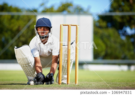 Cricket, sports and a man as wicket keeper on a pitch for training, game or competition. Male athlete behind stumps with gear for action, playing professional sport and exercise for fitness or mockup 106947831