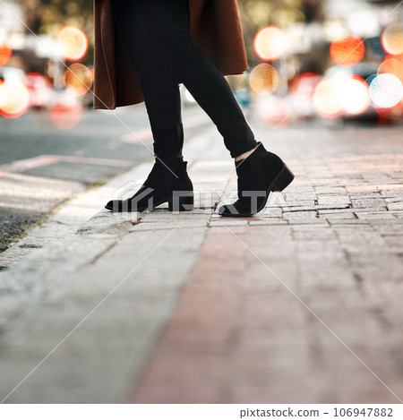 Woman, legs and walking on road in the city for travel, tourism or sightseeing in the outdoors. Closeup leg of female person or traveler with high heel shoes cross street or taking walk in an urban Woman, legs and walking on road in the city for travel, tourism or sightseeing in the outdoors. Closeup leg of female person or traveler with high heel shoes cross street or taking walk in an urban 106947882