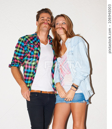 Photobooth couple, man and woman with funny face, gen z fashion and happy university youth culture. Happiness, cool people at crazy and fun college event or celebration on white wall background. Photobooth couple, man and woman with funny face, gen z fashion and happy university youth culture. Happiness, cool people at crazy and fun college event or celebration on white wall background. 106948003