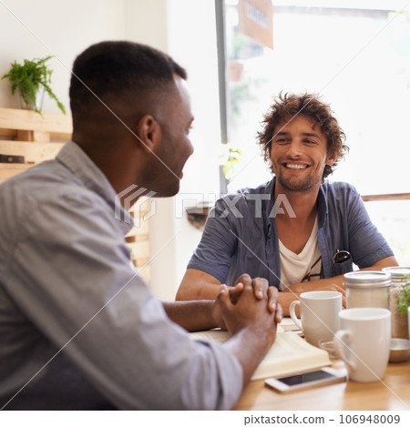 Dude, so how are you doing. Two young men having a conversation while having coffee at a cafe. Dude, so how are you doing. Two young men having a conversation while having coffee at a cafe. 106948009
