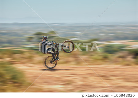 Extreme sports, bicycle and man cycling in the countryside for fitness, stunt and freedom. Nature, biking and sporty male cyclist training, practice and speed, action and free on Mexico dirt road 106948020