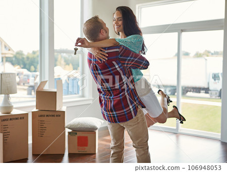 Happy couple, keys and moving into new home or hug for mortgage or property buy and boxes in empty lounge together. Real estate, man and woman excited for rent or embrace and house with open space 106948053