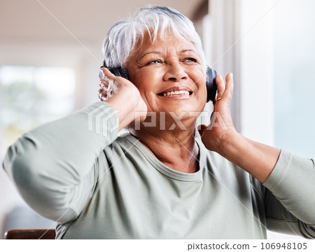 My soul can still dance. Shot of a beautiful senior woman listening to music while sitting on the sofa at home. My soul can still dance. Shot of a beautiful senior woman listening to music while sitting on the sofa at home. 106948105