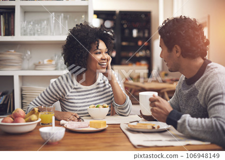 Enjoying a leisurely breakfast together. Shot of a couple eating breakfast together at home. 106948149