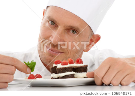 Fruit, baking and portrait of a chef with cake presentation isolated on a white background in a studio. Smile, food and face of a professional baker with a sweet chocolate dessert for catering 106948171