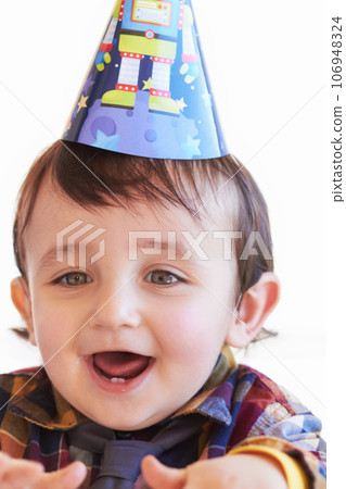 Do want. Shot of a cute little boy wearing a party hat looking excited. Do want. Shot of a cute little boy wearing a party hat looking excited. 106948324