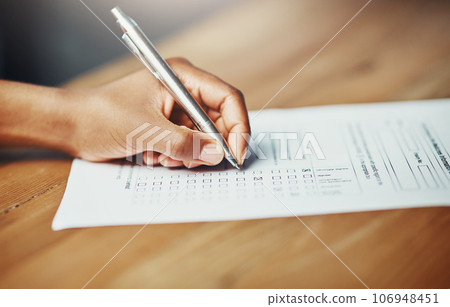 Her opinion matters. Closeup of a female hand filing in paperwork for a formal application or survey. A woman writing on a form applying for a financial loan, completing a list or questionnaire. 106948451