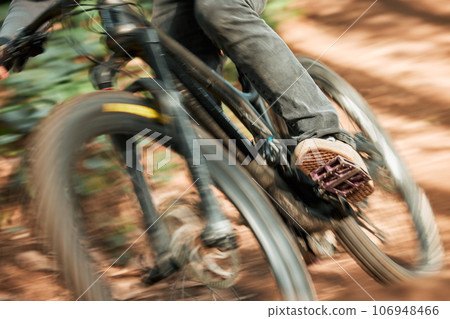 Feet, mountain bike pedal and speed in forest, closeup and training for health, wellness and outdoor adventure. Person, cycling and bicycle with fast race, exercise and workout with balance off road Feet, mountain bike pedal and speed in forest, closeup and training for health, wellness and outdoor adventure. Person, cycling and bicycle with fast race, exercise and workout with balance off road 106948466