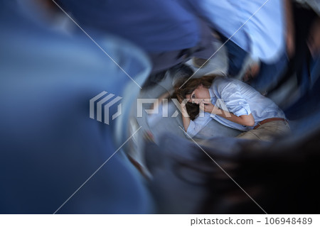 Its all too much. Shot of a young woman curled up on the floor in a panic state. 106948489