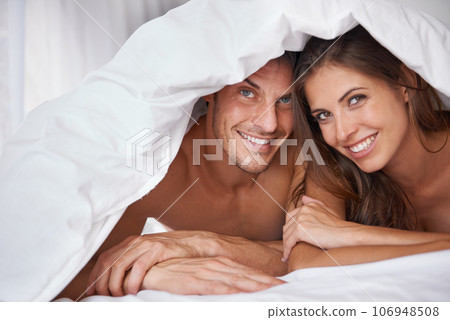 Love, portrait and couple in bed, waking up and bonding in a bedroom together, flirting and romantic. Face, man and woman relax, intimate and resting at hotel for valentines day, anniversary or bond Love, portrait and couple in bed, waking up and bonding in a bedroom together, flirting and romantic. Face, man and woman relax, intimate and resting at hotel for valentines day, anniversary or bond 106948508