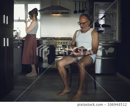 Marriage, problem and mental health issue with bored old couple in toxic, dark or sad family home kitchen together. Divorce, alcoholic and depression married relationship with broken household 106948512