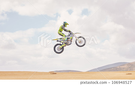 Desert, motorbike cycling and jump for sports, agile driving and off road adventure with mockup space in cloudy sky. Motorcycle, challenge and moving in air for action, fearless talent and sand dunes Desert, motorbike cycling and jump for sports, agile driving and off road adventure with mockup space in cloudy sky. Motorcycle, challenge and moving in air for action, fearless talent and sand dunes 106948527