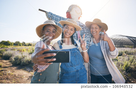 Farmer, women peace sign and selfie in countryside with team and scarecrow outdoor with a smile. Diversity, worker group and happy with social media and profile picture on a agro farm and field Farmer, women peace sign and selfie in countryside with team and scarecrow outdoor with a smile. Diversity, worker group and happy with social media and profile picture on a agro farm and field 106948532