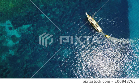 Aerial, boat and sailing in water, summer on ocean holiday and relax in freedom with nature from above. Yacht vacation, travel in Croatia and tropical cruise on sea adventure to island in sunshine. Aerial, boat and sailing in water, summer on ocean holiday and relax in freedom with nature from above. Yacht vacation, travel in Croatia and tropical cruise on sea adventure to island in sunshine. 106948765