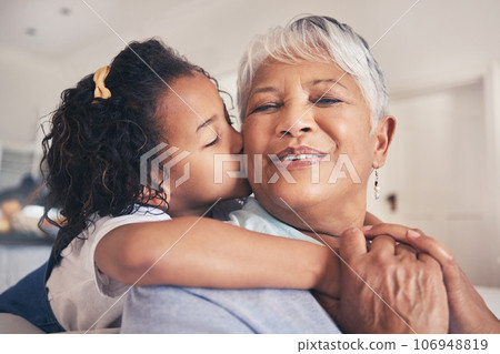 Hug, kiss or child with grandma in living room of family house with trust, care or love in retirement. Senior granny, face or happy grandmother bonding with kid to relax with smile, joy or freedom 106948819