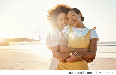 Portrait, hug and lgbt couple on the beach together for romance or relationship bonding on a date. Mockup, sunset and a gay woman with her lesbian girlfriend by the sea or ocean for their honeymoon 106948888