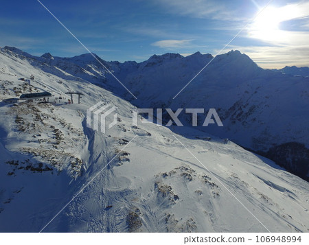 Morning, sunshine and mountains with snow in the winter for travel, climbing and hiking. Landscape, nature and the view of a natural environment with a blue sky in the Alps for adventure on rocks Morning, sunshine and mountains with snow in the winter for travel, climbing and hiking. Landscape, nature and the view of a natural environment with a blue sky in the Alps for adventure on rocks 106948994