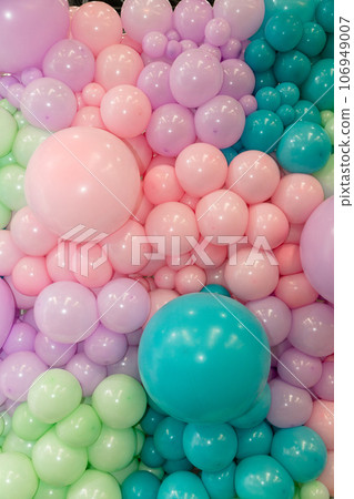 Many colorful balloons decorated wall as background 106949007