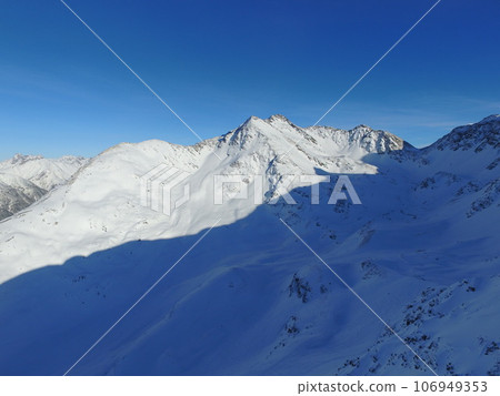 Mountain, snow and sky on the Swiss Alps for travel, holiday or vacation with a view of nature. Environment, landscape and adventure in a remote location in cold weather season of winter in Europe 106949353