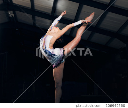 Fitness, stretching and performance with a dance woman in a gym for training or practice for a competition. Exercise, event and form with a female gymnastic or rhythmic dancer in a workout studio 106949368