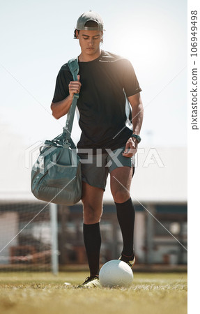 Football, training and exercise man with ball on sport field after training, practice and workout with bag. Athlete, soccer and fitness on sports ground after healthy sports cardio outdoor in summer Football, training and exercise man with ball on sport field after training, practice and workout with bag. Athlete, soccer and fitness on sports ground after healthy sports cardio outdoor in summer 106949498