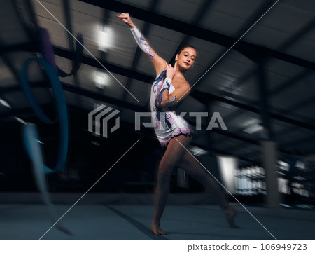 Fitness, performance and motion blur with a dance woman in a gym for training or practice for a competition. Exercise, event and energy with a young gymnastic or rhythmic dancer in a workout studio Fitness, performance and motion blur with a dance woman in a gym for training or practice for a competition. Exercise, event and energy with a young gymnastic or rhythmic dancer in a workout studio 106949723