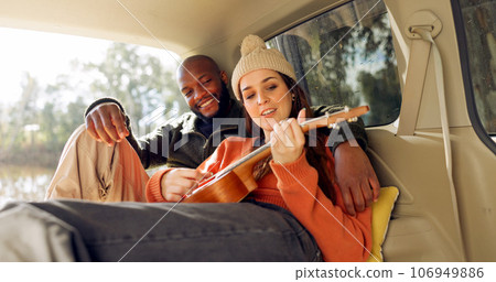 Singing with Guitar, winter and a couple in a car for a road trip, date or watching the view together. Happy, travel and back of a man and woman with an affection in transport during a holiday or cam 106949886