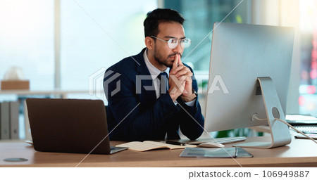 Business man analyzing a project strategy on a computer screen while working in an office. Serious and focused corporate professional thinking of solutions while considering ideas, choices and plans 106949887