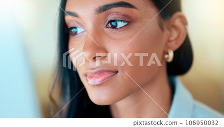 Business woman reading information on a computer screen while working in an office. Closeup on face of one confident young entrepreneur and focused expert carefully analyzing ideas and plans online Business woman reading information on a computer screen while working in an office. Closeup on face of one confident young entrepreneur and focused expert carefully analyzing ideas and plans online 106950032