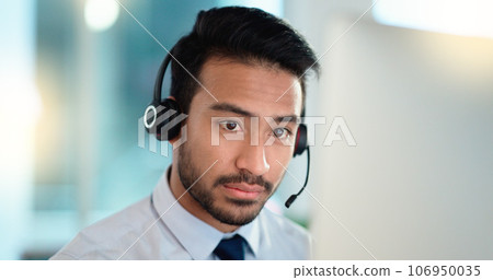 Call center agent talking and listening to a client on a headset while working in an office. Confident and reassuring salesman consulting and operating a helpdesk for customer service and support 106950035