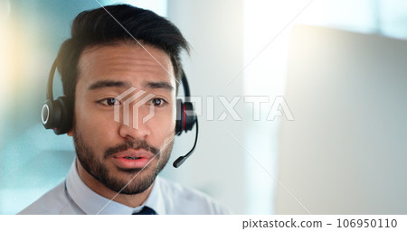Call centre agent wearing headset giving great customer support service via email at his desk. Confident young sales representative making a sale at his helpdesk in the office. Operator sends invoice 106950110