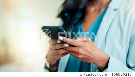Closeup of a woman texting, browsing and scrolling on a phone in an office. Hands of a corporate executive, busy entrepreneur and business expert typing a message while networking with clients online Closeup of a woman texting, browsing and scrolling on a phone in an office. Hands of a corporate executive, busy entrepreneur and business expert typing a message while networking with clients online 106950213