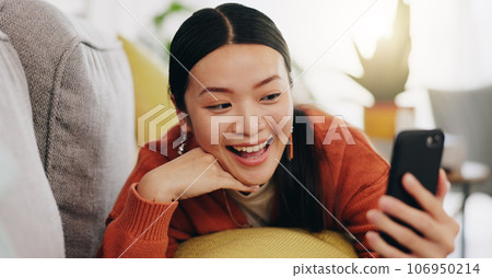 Asian woman, selfie and lying on sofa with peace sign and love for profile picture, vlog or social media at home. Happy female relaxing with smile and hand signs for photo or online vlogging on couch 106950214