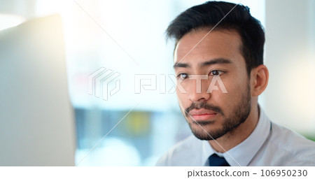 Business man reading his emails and browsing online on a desktop computer while working in an office at work. One male corporate worker while networking and connecting with clients on the internet 106950230