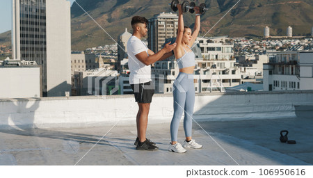Fitness, personal trainer and a woman outdoor with dumbbells for exercise, workout or training rooftop. Couple of friends in urban city for sports, strong muscle or bodybuilder and lifting weights Fitness, personal trainer and a woman outdoor with dumbbells for exercise, workout or training rooftop. Couple of friends in urban city for sports, strong muscle or bodybuilder and lifting weights 106950616
