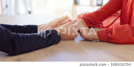 Love, empathy and friends holding hands in comfort, support or solidarity during grief, loss or mourning. Depression, mental health and anxiety with two people praying together in trust for help 106950704