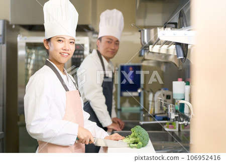 Cooking staff looking at you with a smile Cooking staff looking at you with a smile 106952416