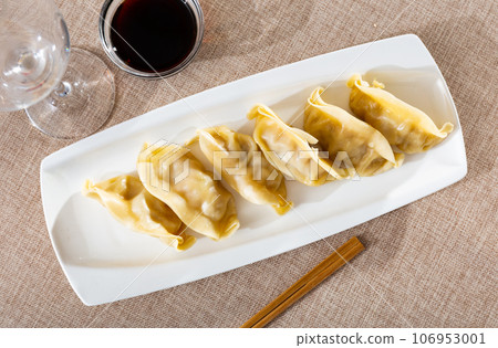 Japanese boiled gyoza dumplings served with tare sauce Japanese boiled gyoza dumplings served with tare sauce 106953001